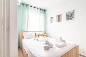 a bedroom with a bed with towels on it at Renovated Studio near Downtown in Heraklio