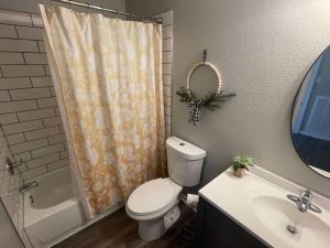 a bathroom with a toilet and a shower and a sink at The Ingrid Apt #8 - Fresh and Simple 2bd with WiFi in Hamilton