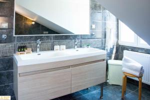 a bathroom with a white sink and a toilet at Serenity Domus in Lefkimmi