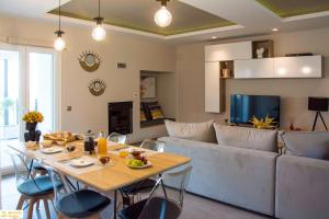 a living room with a table and a couch at Serenity Domus in Lefkimmi +62 photos