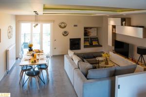 a living room with a couch and a table at Serenity Domus in Lefkimmi