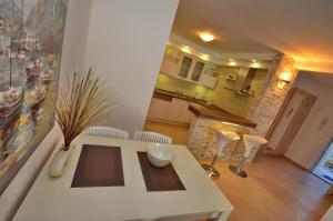 a kitchen and living room with a table and chairs at Muo Apartments in Kotor