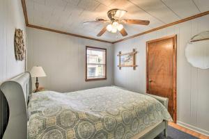 a bedroom with a bed and a ceiling fan at Nags Head Cottage Screened Porch, Walk to Beach! in Nags Head