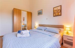 a bedroom with two beds with blue and white sheets at Amazing Home In Valtura With House A Panoramic View in Valtura