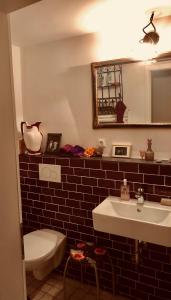 a bathroom with a sink and a toilet and a mirror at Schwedenliebe in Frechen