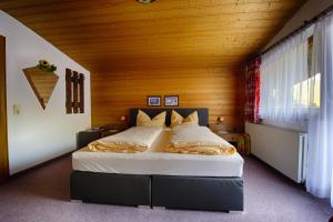 a bedroom with a large bed with a wooden ceiling at Garni Fischer in Oetz