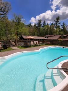a large blue swimming pool in a yard at Magnolia Streamside Resort in Canadensis