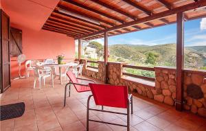 a patio with a table and chairs and a large window at Amazing Home In Torre Dei Corsari With Kitchen in Torre Dei Corsari