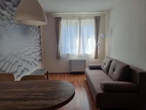 a living room with a couch and a table at Panorama View Apartment in Hajdúszoboszló