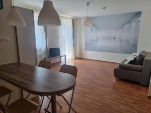 a living room with a table and a couch at Panorama View Apartment in Hajdúszoboszló