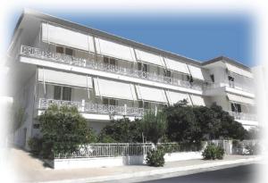 a white building with a balcony on the side of it at Araliki Apartments & Studios in Loutra Edipsou
