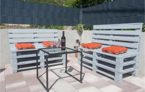 a table with a bottle of wine and a wine glass at 2 Bedroom Gorgeous Home In Gata in Gata