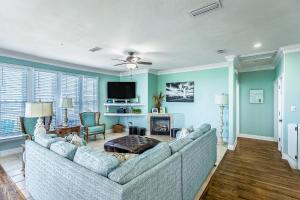 a living room with a couch and a tv at Lighthouse By The Sea in St. George Island