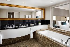 a bathroom with two sinks and a bathtub at Fairmont Vancouver Airport In-Terminal Hotel in Richmond