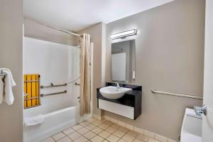a white bathroom with a sink and a toilet at Motel 6 Virginia Beach in Virginia Beach +40 photos