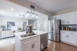 a kitchen with white cabinets and a stainless steel refrigerator at Blue Haven ATL in Atlanta