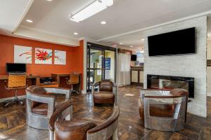 a lobby with a fireplace and chairs and a tv at Best Western Allatoona Inn & Suites in Cartersville