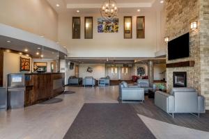 a lobby with a living room and a fireplace at Best Western Plus Bridgewater Hotel & Convention Centre in Bridgewater