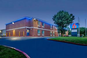 a red brick building with a sign in front of it at Motel 6 Tulsa, Ok - Central in Tulsa