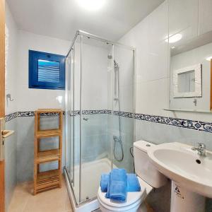 a bathroom with a shower and a toilet and a sink at Cotillo Ocean in El Cotillo