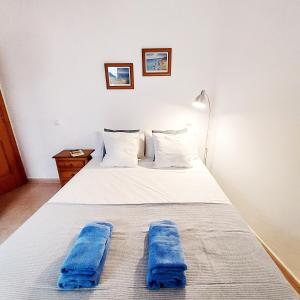 a bedroom with a bed with blue towels on it at Cotillo Ocean in Cotillo
