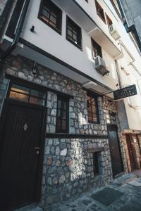 un edificio de piedra con una puerta y ventanas negras en Villa Fortuna en Ohrid