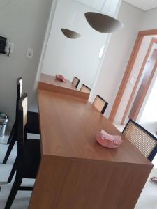 a wooden table with chairs and a bowl on it at Salinas exclusive Ary Costa in Salinópolis