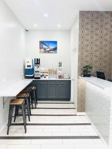 a kitchen with a counter and stools in a room at Bay Hotel in San Francisco