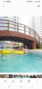 two people are laying on rafts in a swimming pool at Salinas exclusive Ary Costa in Salinópolis