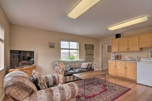 a living room with two couches and a table at Charming Barn Apt in Boulder! Gateway to Parks! in Boulder Town