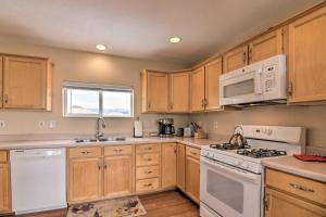 a kitchen with white appliances and wooden cabinets at Charming Barn Apt in Boulder! Gateway to Parks! in Boulder Town