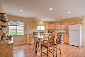 a kitchen with a table and chairs and a refrigerator at Charming Barn Apt in Boulder! Gateway to Parks! in Boulder Town