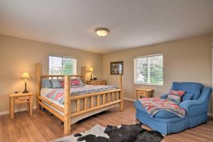 a bedroom with a bed and a blue chair at Charming Barn Apt in Boulder! Gateway to Parks! in Boulder Town