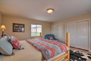 a bedroom with a bed and a blue chair at Charming Barn Apt in Boulder! Gateway to Parks! in Boulder Town