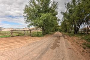 a dirt road with trees and a fence on it at Charming Barn Apt in Boulder! Gateway to Parks! in Boulder Town