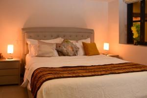 a bedroom with a large bed with pillows at Casa Lorenza Hotel in Cartagena de Indias