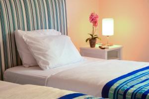 Postel nebo postele na pokoji v ubytování Casa Lorenza Hotel