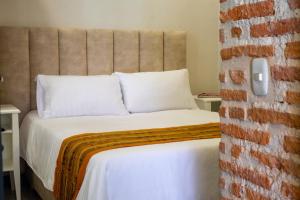 Postel nebo postele na pokoji v ubytování Casa Lorenza Hotel