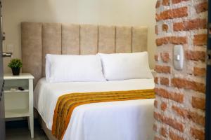 Postel nebo postele na pokoji v ubytování Casa Lorenza Hotel