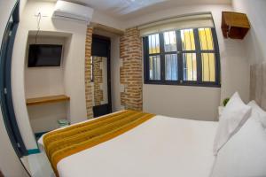Postel nebo postele na pokoji v ubytování Casa Lorenza Hotel