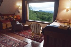 a bedroom with a bed and a large window at Mount Harmony Farm Guest House in Sheffield