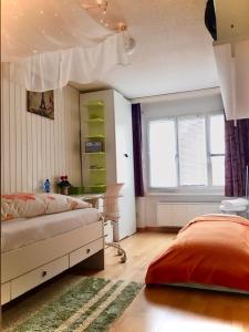 a bedroom with a bed and a desk and a window at Walenstadt in Seenähe B & B in Walenstadt