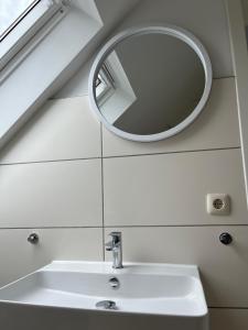 a bathroom with a mirror and a sink at Connect 9.1 in Dorum-Neufeld
