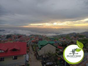 a view of a city at sunset with a sticker at ARSIAM Transient Room in Baguio