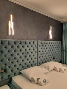 a bedroom with a bed with two lights on the wall at Pensiunea Ramina in Adjud