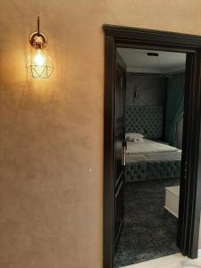 a door to a bedroom with a mirror and a bed at Pensiunea Ramina in Adjud