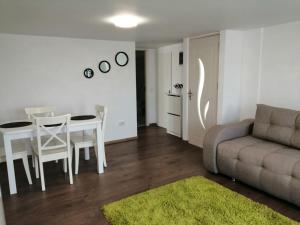 a living room with a couch and a table at Lovely loft in Cluj-Napoca