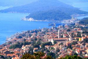 an aerial view of a town on a hill next to the water at Apartments by the sea Mali Losinj, Losinj - 19959 in Mali Lošinj