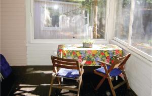 a table and two chairs on a porch at Two-Bedroom Holiday Home In Yngsjo in Yngsjö