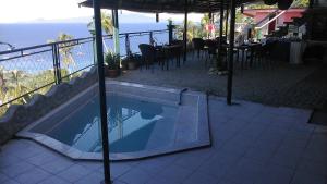 a swimming pool on a balcony with a view of the ocean at Dream Hill Condos & Spa in Puerto Galera